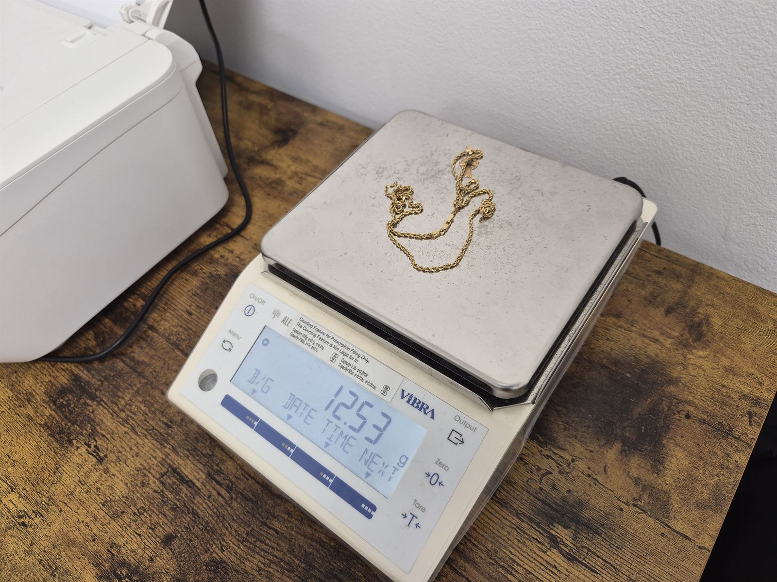 A 12.53 gram gold rope chain being weighed on our precision scale during a live appraisal